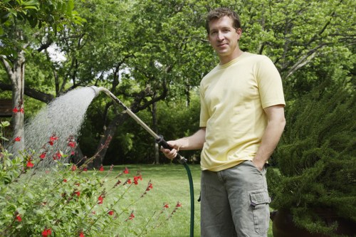 Gardener trimming hedges during spring in Maida Vale
